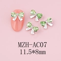 Macro detail of bow-shaped nail charms with light green rhinestones and silver base - Silver Base Light Green (AC07)