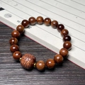 Rosewood prayer bead bracelet with carved cloud pattern bead on vintage book - 10mm Bead With Carved Cloud Pattern