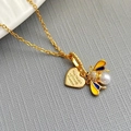 Detailed close-up of golden heart pendant with bee, pearl, and colorful enamel inlay - Bee Heart-Gold 0382J