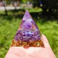 Macro shot of an Orgone energy pyramid with amethyst ball and gold foil held in hand - B-2-2 Amethyst Mandala / 5cm