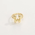 Macro detail of high-polish gold adjustable ring featuring a fluid letter W design - Gold Ring W