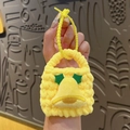 Handmade knitted yellow bell charm bag with festive green leaf accents and matching lanyard - Style with Bells
