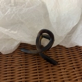 Macro view of a dark amber tortoise shell hair claw clip with a twisted figure-8 design - Frosted Black-Yellow