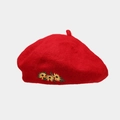 Detail of red wool beret featuring delicate yellow sunflower embroidery on a felt surface - Red