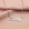 Detail of silver bar necklace featuring a hollow heart cutout on a pink silk background - Hollow Heart Style (MP340-4) / Steel