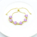 Detail of gold evil eye bracelet with purple enamel heart charm and clear zircon stones - Light Purple