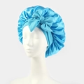 Detailed macro view of light blue satin sleep bonnet with a large decorative bow - One Size / Lake Blue