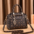 Elegant dark brown handbag with vintage monogram print and golden leaf pendant - Solid Coffee