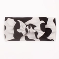 Detail of soft black and white cow print baby headband with a wide-brimmed bow knot - Style E (Cow Print)