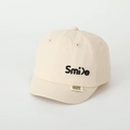 Close-up of Smile embroidery and brand tag on beige baseball cap for kids - 48-52cm (Adjustable) / Smile Embroidery Beige