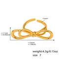 Detail showing 3.6x1.1cm golden bow knot ring measurements and copper material details - US 7 / Gold