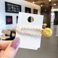 Elegant pearl hair clip with yellow smiley face charm on minimalist gold alloy base - Smiley Face Pearl Row Clip / Yellow Smiley Face