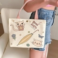 Beige canvas small handbag with cute cartoon cat print and pink woven handle - Umbrella Cat