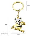 Porte-clés panda snowboarder doré en émail noir et blanc, poids 14g, hauteur 36mm - Panda de Ski (Or)