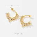Detail view of 24mm irregular C-hoop gold earrings with zircon stones and weight specs - 18K Gold