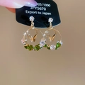 Detail of 925 silver gold butterfly earrings with green cubic zirconia and crystal stones - Green Butterfly Round Style / Green
