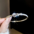 Macro shot of silver bow bracelet with pave-set sparkling cubic zirconia crystals - Silver (Bow Knot)