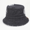 Detail of distressed denim bucket hat showing frayed holes and leather patch - M (56-58cm) / Black