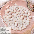 Macro shot of 1cm white pearl flower resin beads for DIY jewelry making with 2mm hole - Small Plum Blossom