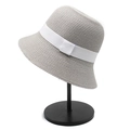 Detail of gray straw bucket hat with a white ribbon bow on a display stand - M(56-58cm) / Grey (with White Ribbon)