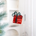 Red Christmas gift bag metal ornament with white snowflakes and green ribbon bow - Bow Gift Box