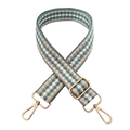 Close-up of geometric jacquard bag strap with gold metal hooks and adjustable buckle - White Blue Beige