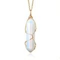 Close-up of hexagonal opal crystal pendant with golden wire wrap on a fine chain necklace - Opal