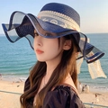 Navy blue straw sun hat with wavy brim, white lace embroidery, and handmade flowers - Wave Rose Navy Blue