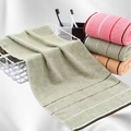 Macro detail of soft cotton towels in assorted colors neatly folded in a basket - 32x70cm / Olive Green