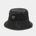 Close-up of heart embroidery and metallic eyelets on washed vintage bucket hat - One Size / Black