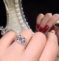 Elegant princess cut cubic zirconia ring with intertwined band on hand model - Ur0667