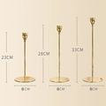 Three gold metal candlesticks in different heights of 23cm, 28cm and 33cm with sleek design - 6036 Candle Holders Set of 3