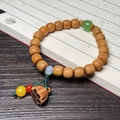 Bamboo style sandalwood bead bracelet with green barrel bead and carved lotus pendant - Sandalwood Classic 8x9mm with Lotus Seed Pod