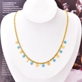 Titanium steel gold necklace featuring blue and yellow star charms on a neck model - Star Necklace