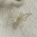 Translucent butterfly hair claw clip with iridescent finish on textured fabric - Holographic Mermaid Butterfly Claw