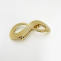 Macro detail of golden metal infinity hair clip with textured surface and punk style - Infinity 8-Shape Gold