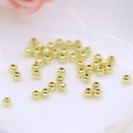 Macro-opname van 18K vergulde gladde tussenkralen voor DIY-sieraden maken - 3mm (1.2mm Gat) / 14K Goud