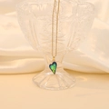 Elegant gold chain necklace with a gradient heart pendant on a romantic silk background - Peacock Green