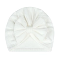 Detail of white newborn baby turban hat featuring a soft ribbed knit and a large bow - White