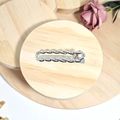 Silver alloy hair clip with twist design on a wooden coaster with a pink rose - Silver Oval Twist