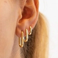 Three-piece gold U-shaped earring set with zircon, showing minimalist style on model ear - 5806001HB/Gold U-Shaped Minimalist Hoop Set