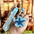Blue sakura starfish keychain with liquid glitter oil and Happy Moments wristband - Blue