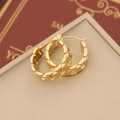 Macro shot of gold hoop earrings with H-letter cutout pattern on jewelry cushion - Letter H Hollow Style (7#)