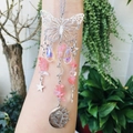 Detail of silver butterfly suncatcher with crystal pendants and moon star charms - Watermelon Red (Synthetic)