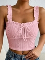 Detailed macro view of pink eyelet embroidery fabric and bow tie on camisole top - S / Pink