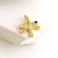 Macro shot of gold-plated dragonfly pendant with white zircon wings and blue evil eye detail - Micro Pave Blue Eye Dragonfly