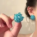 Macro detail of blue beaded sphere earrings showing intricate handmade texture on model - 18# Silver Earring Post - Blue