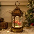 Vintage bronze Christmas lantern featuring red cardinals and falling snow effect - Cardinals