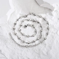 Minimalist silver heart link necklace in stainless steel on white stone background - Silver