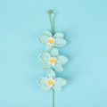 Detailed view of three hand-crocheted blue orchids with white and yellow accents on a stem - Three Orchid Branches / Blue